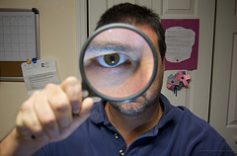 man holding magnifying glass